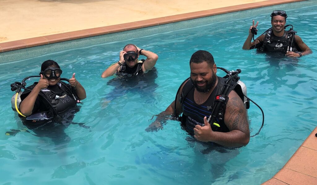 Divers in the pool learning SCUBA skills