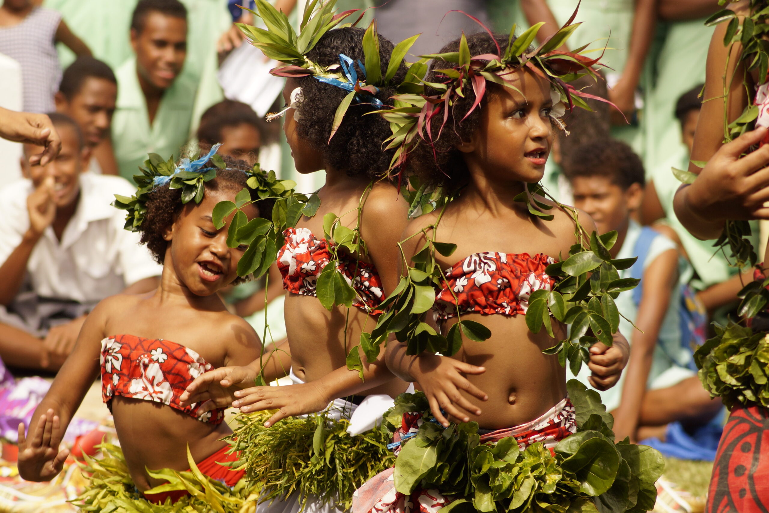 Two young Fijian girls dancing
