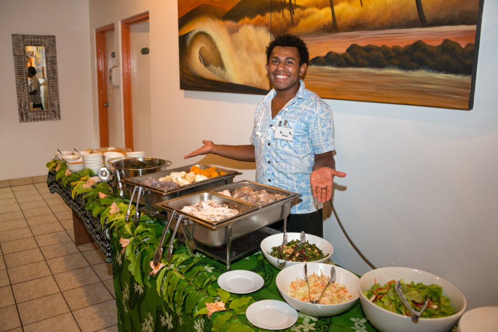 Waidroks staff member welcomes guests to dinner
