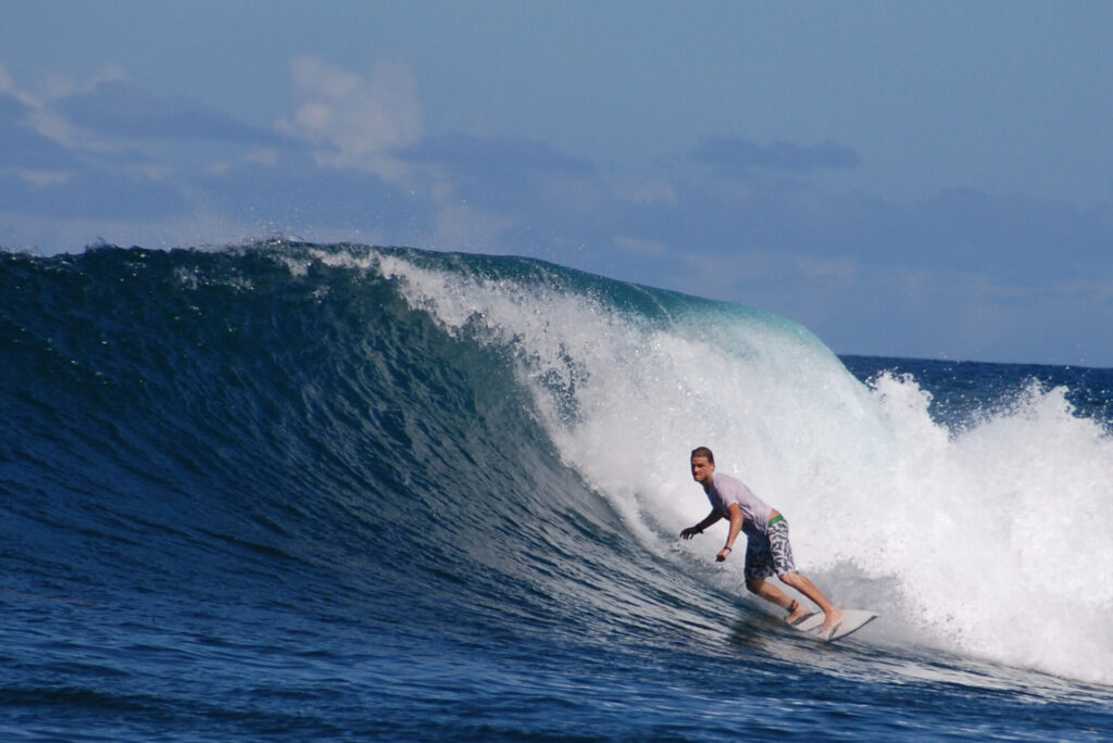 Surfer on a Serua right barrel