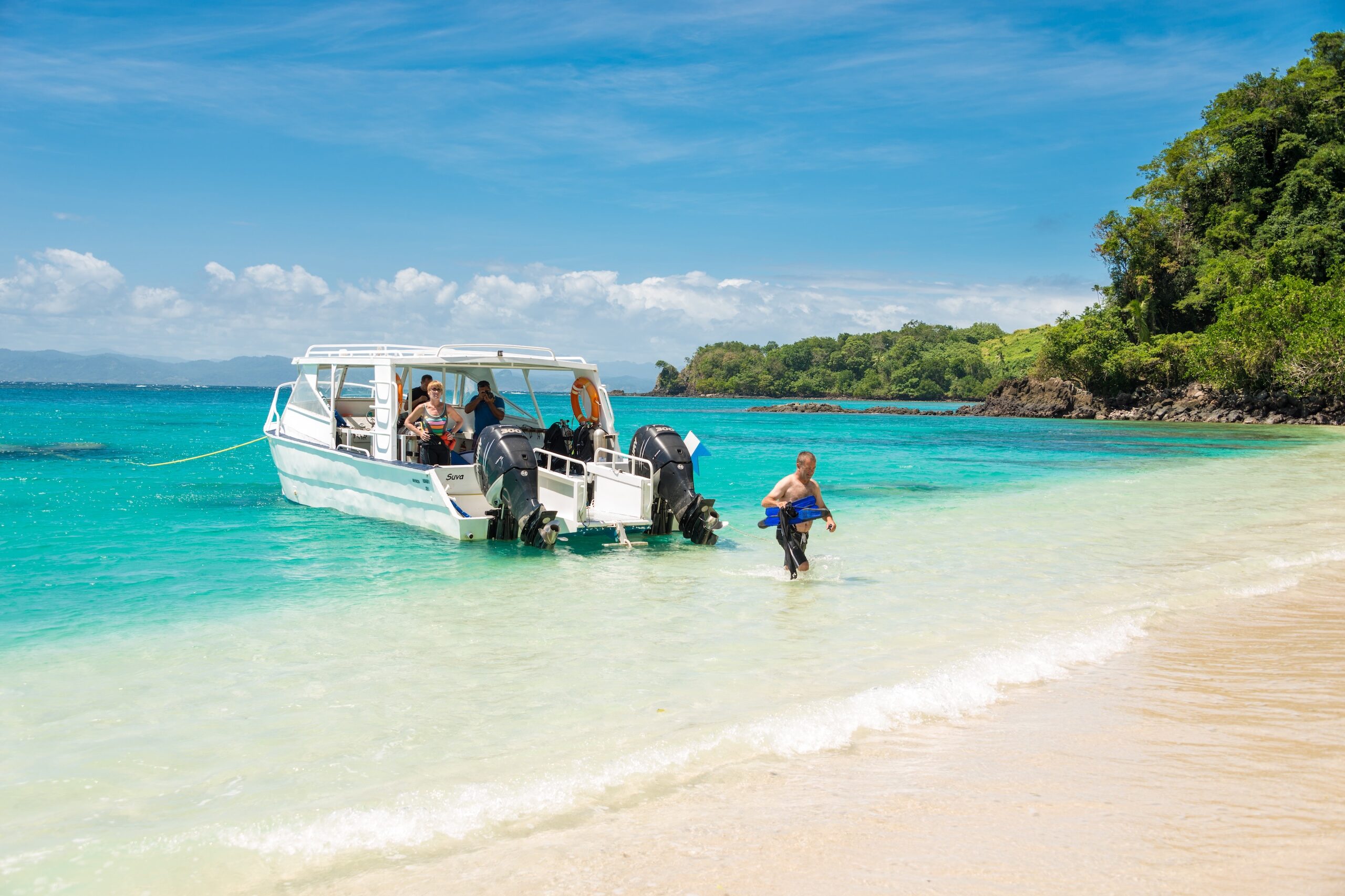 Dive boat arrives at Yanuca Island for a surface interval