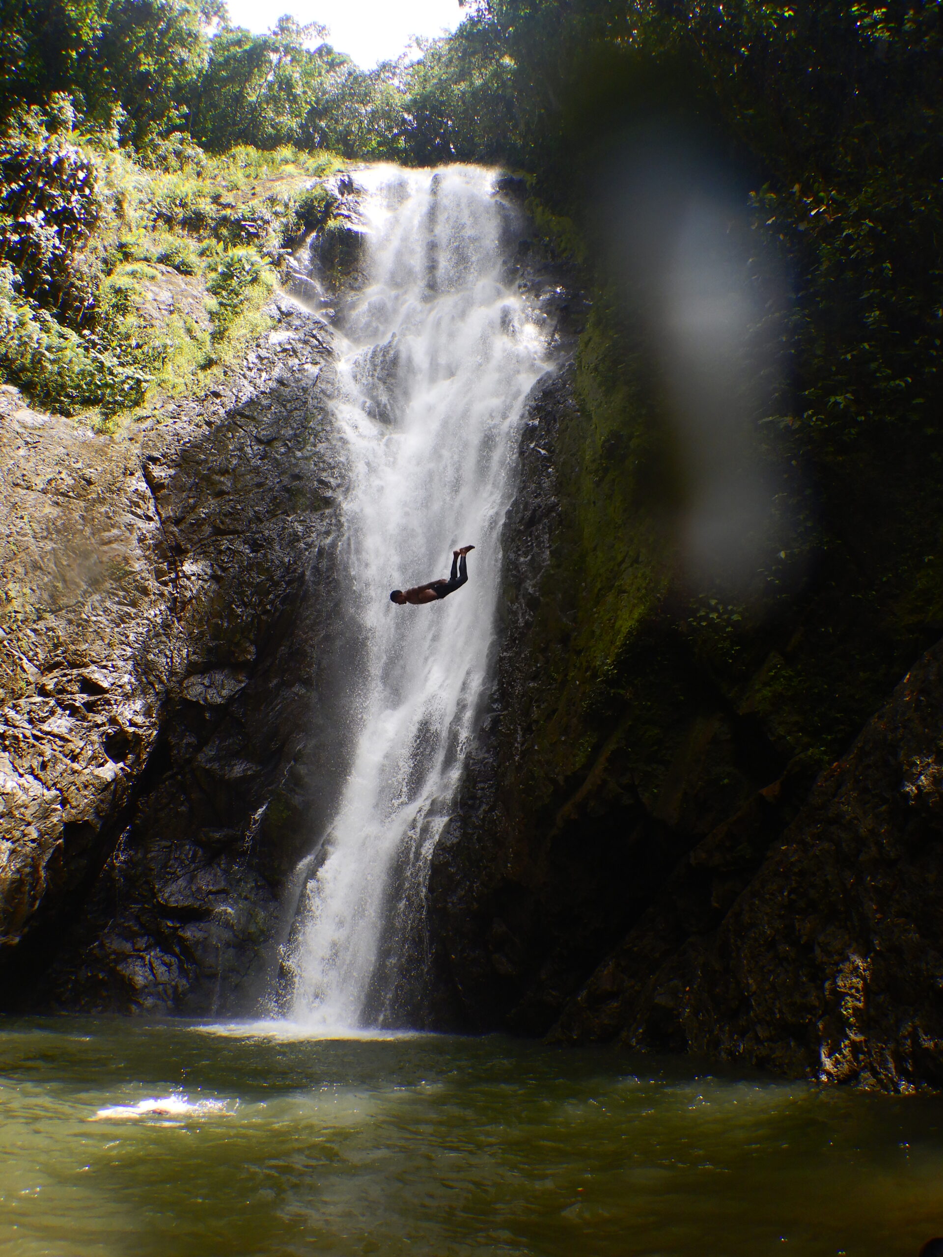 Man jumping off a waterfall
