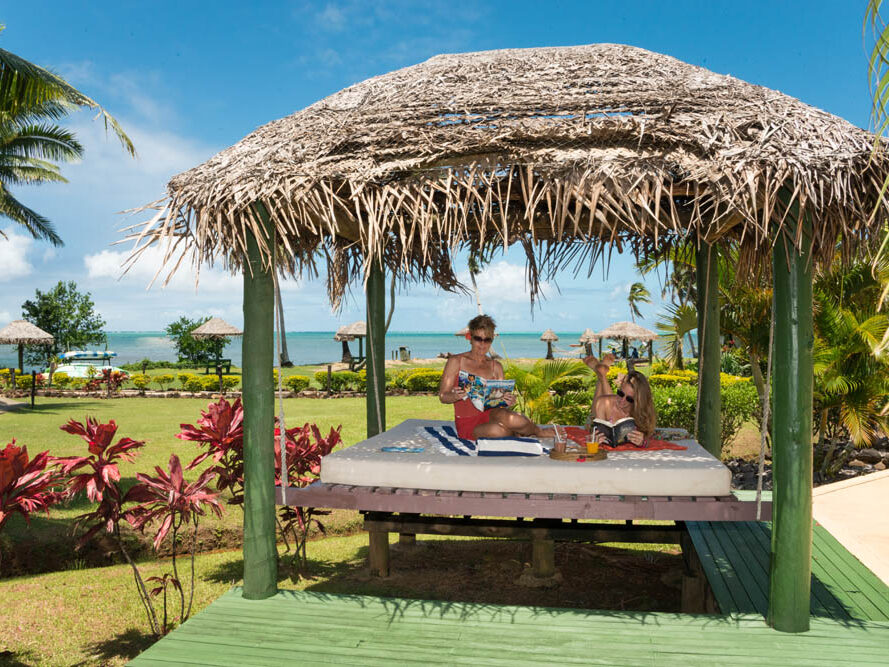 Guests relaxing in an outdoor cabana at Waidroka Bay Resort